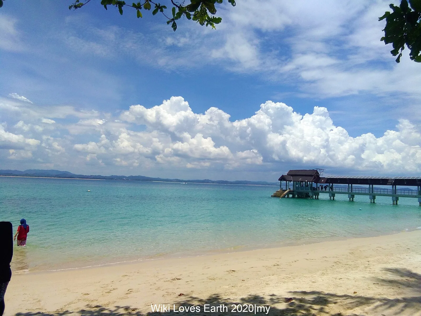 White sand, turquoise sea and a simple jetty at Kapas Island.