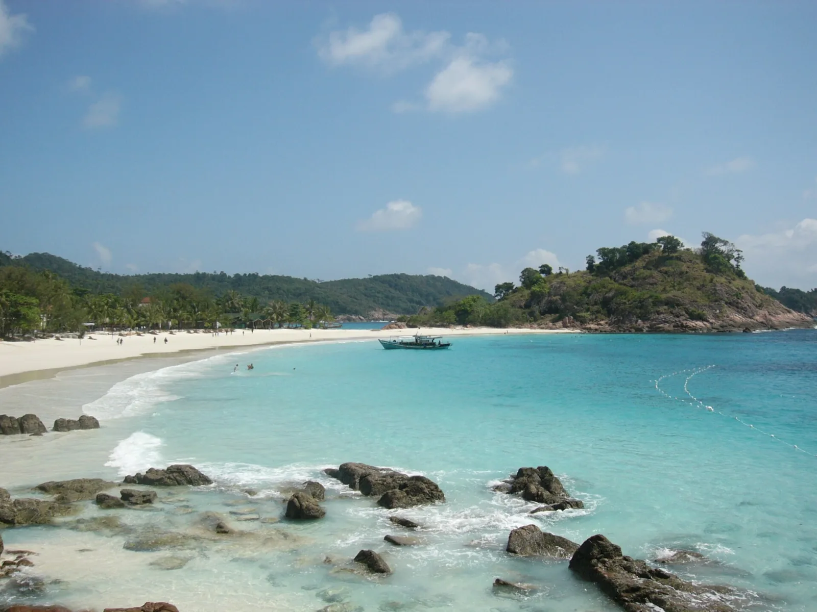 Curved white sand, turquoise water and rocky headlands at Pasir Panjang, Redang.